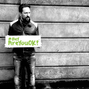 Black and White image of Paul AKA Allotment Junkie holding a sign #HeyAreYouOK